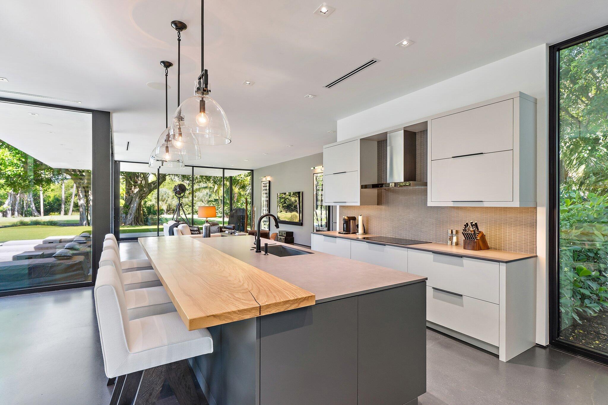 12 North Beach Road Jupiter Island, FL 33455 - Photo 17 of 95 a large kitchen with kitchen island a large counter top space a sink stainless steel appliances and cabinets