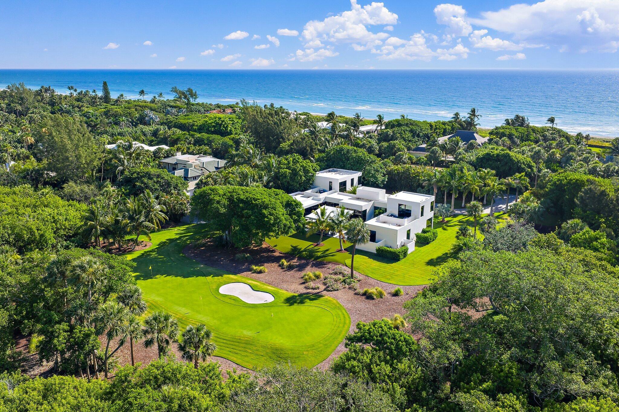 12 North Beach Road Jupiter Island, FL 33455 - Photo 2 of 95 a view of a swimming pool with a yard