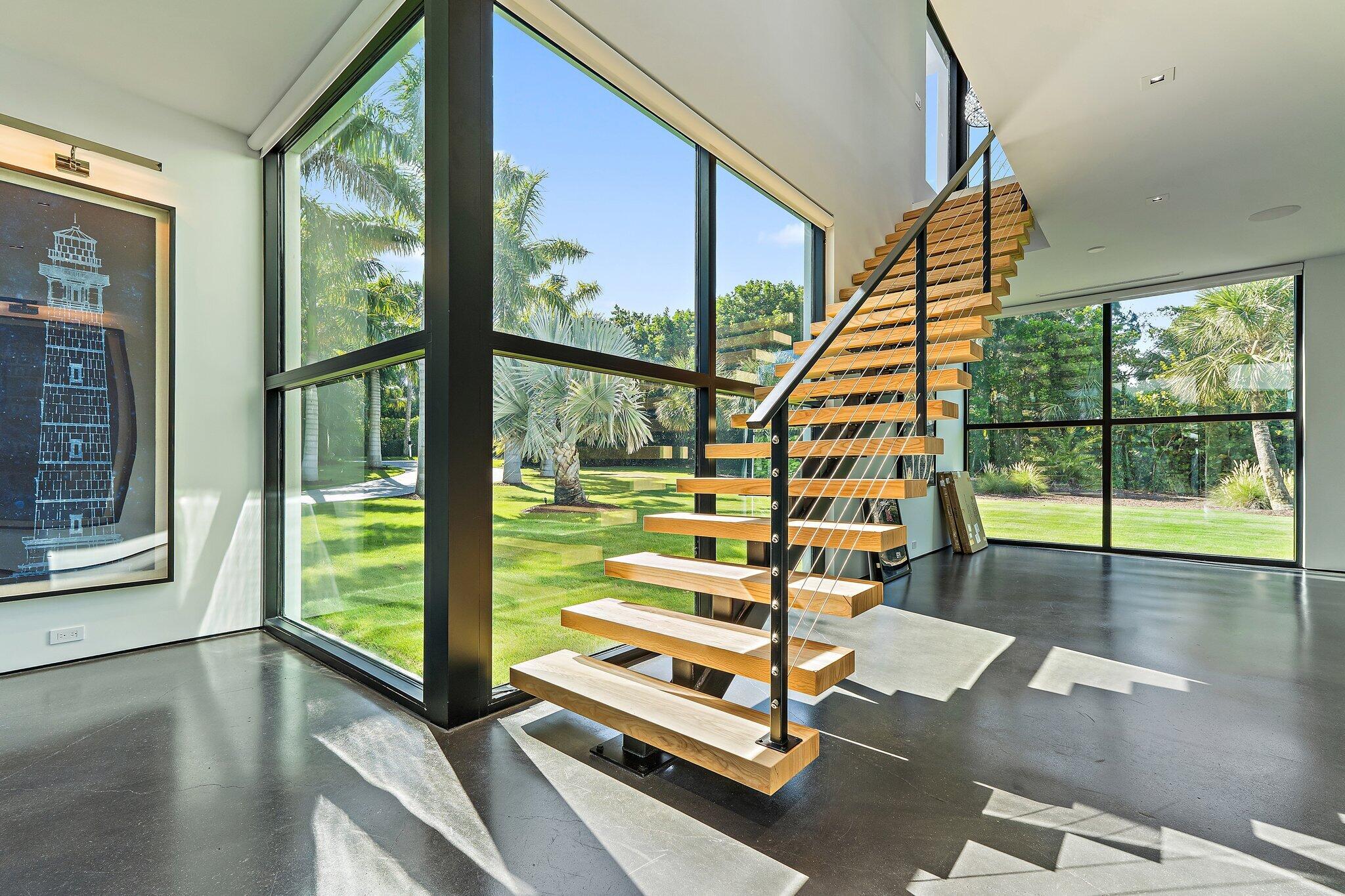 12 North Beach Road Jupiter Island, FL 33455 - Photo 33 of 95 a view of staircase with a floor to ceiling window