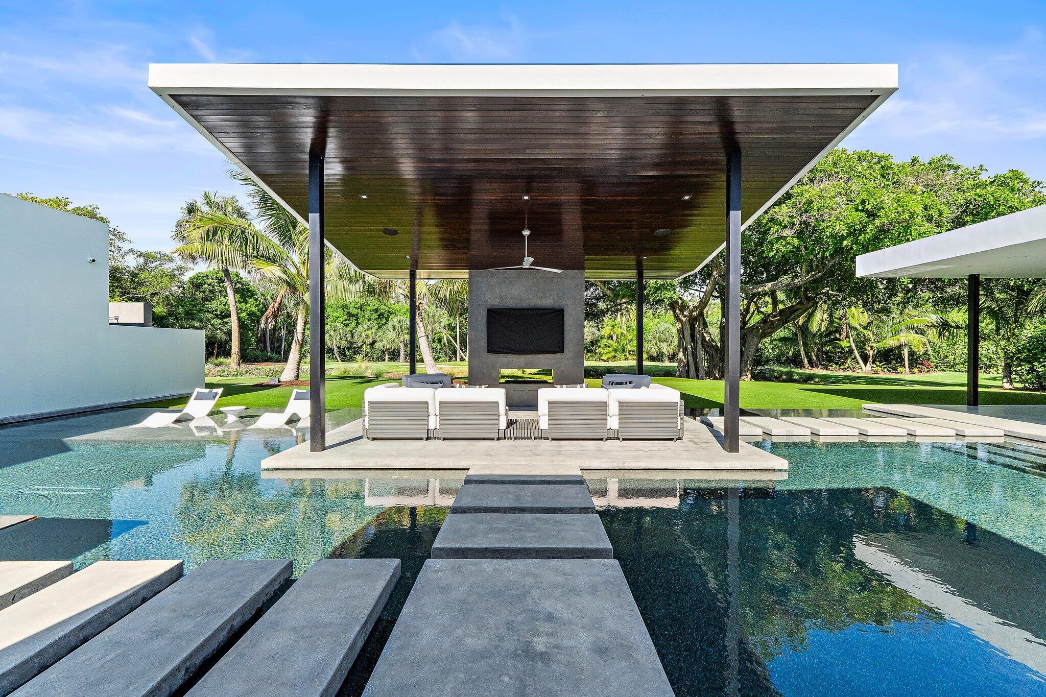 12 North Beach Road Jupiter Island, FL 33455 - Photo 34 of 95 a view of a swimming pool with a patio