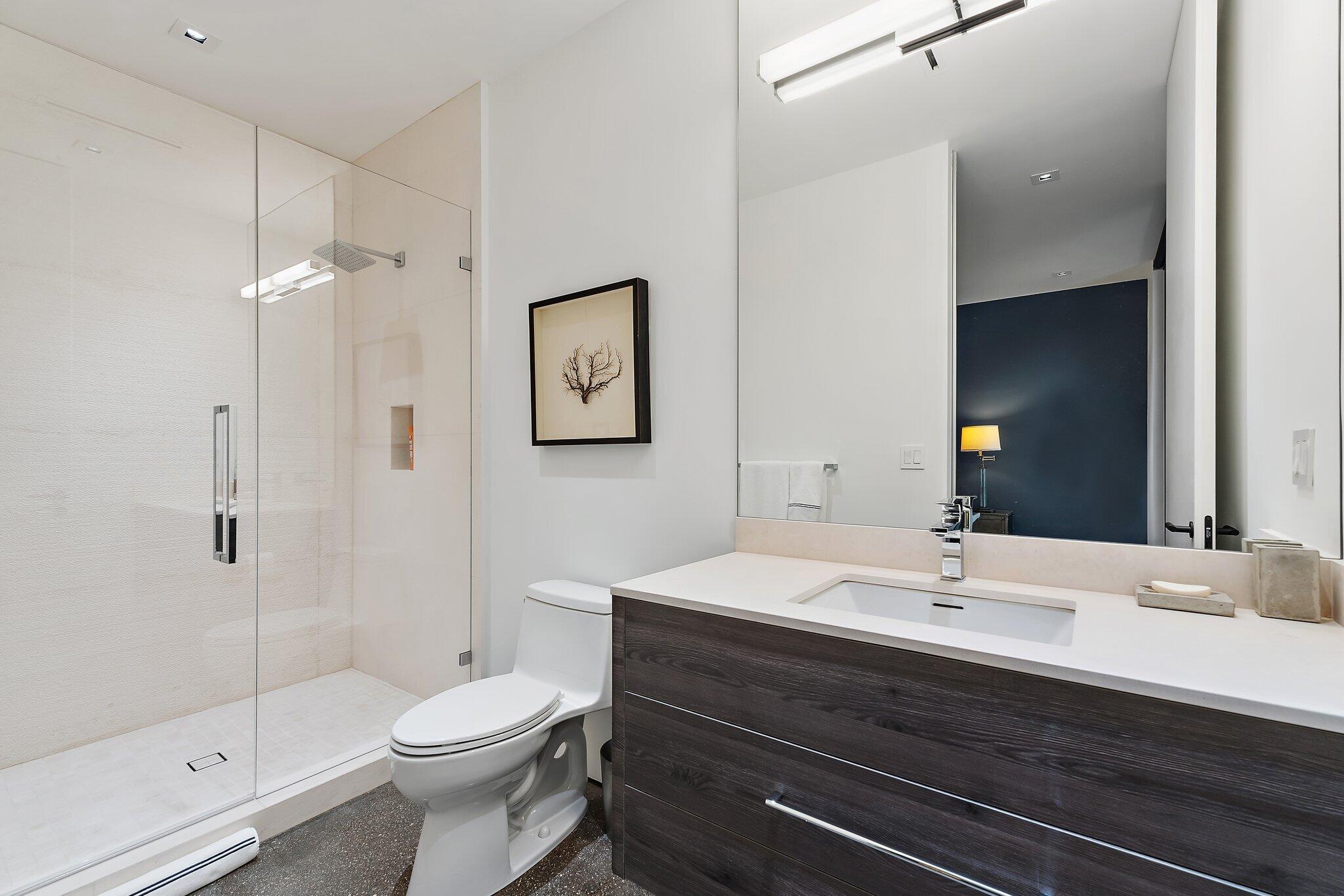 12 North Beach Road Jupiter Island, FL 33455 - Photo 48 of 95 a bathroom with a sink a toilet and shower