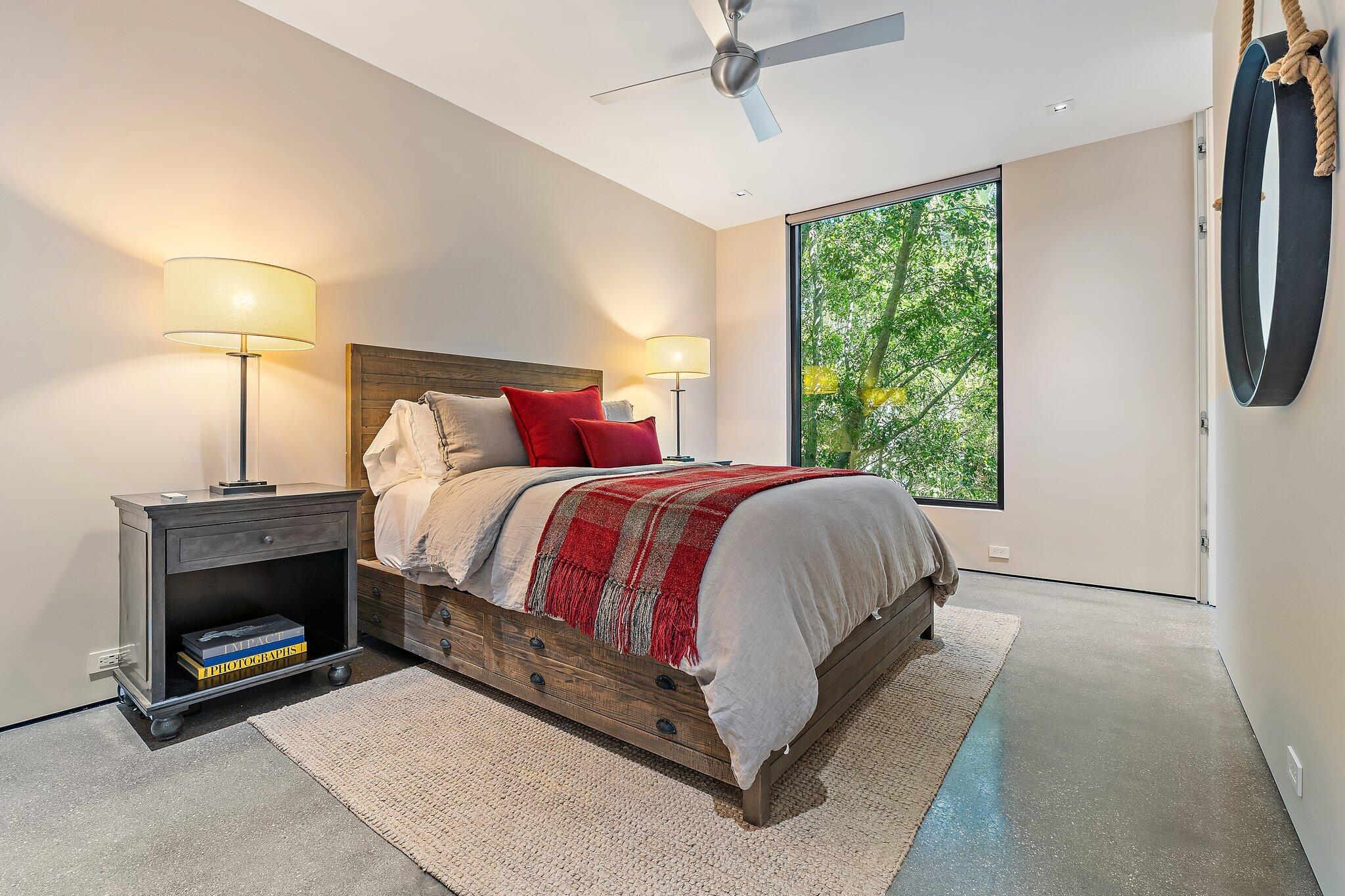 12 North Beach Road Jupiter Island, FL 33455 - Photo 52 of 95 a bed room with a bed and a ceiling fan