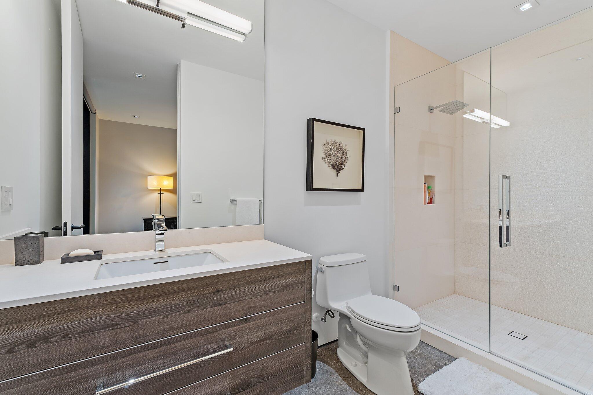 12 North Beach Road Jupiter Island, FL 33455 - Photo 53 of 95 a bathroom with a toilet a sink and shower