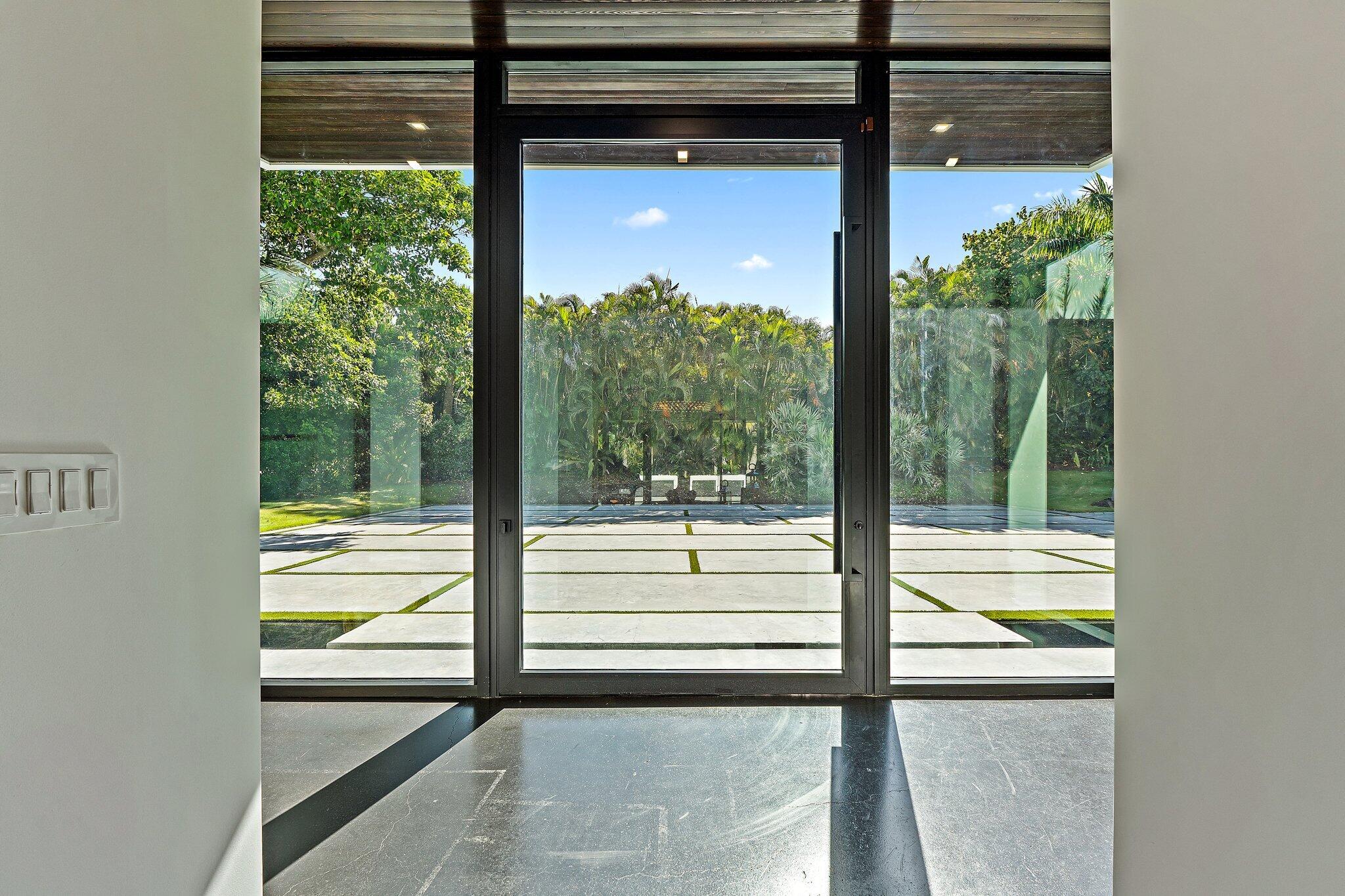 12 North Beach Road Jupiter Island, FL 33455 - Photo 89 of 95 a view of a glass door with a tree