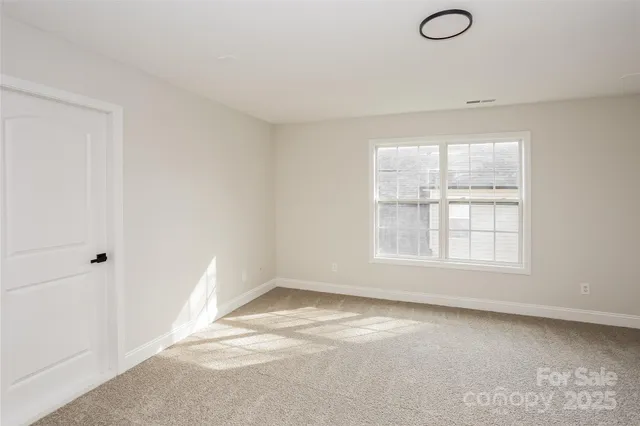 an empty room with a empty space and windows