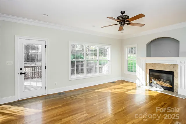a view of an empty room with a fireplace and a window