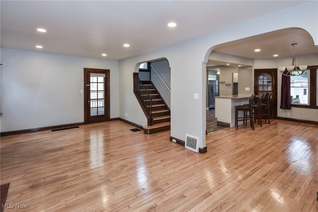 3631 Cummings Road Cleveland, OH 44118 - Photo 6 of 29 Living area featuring arched walkways, light wood-type flooring, recessed lighting, and stairs