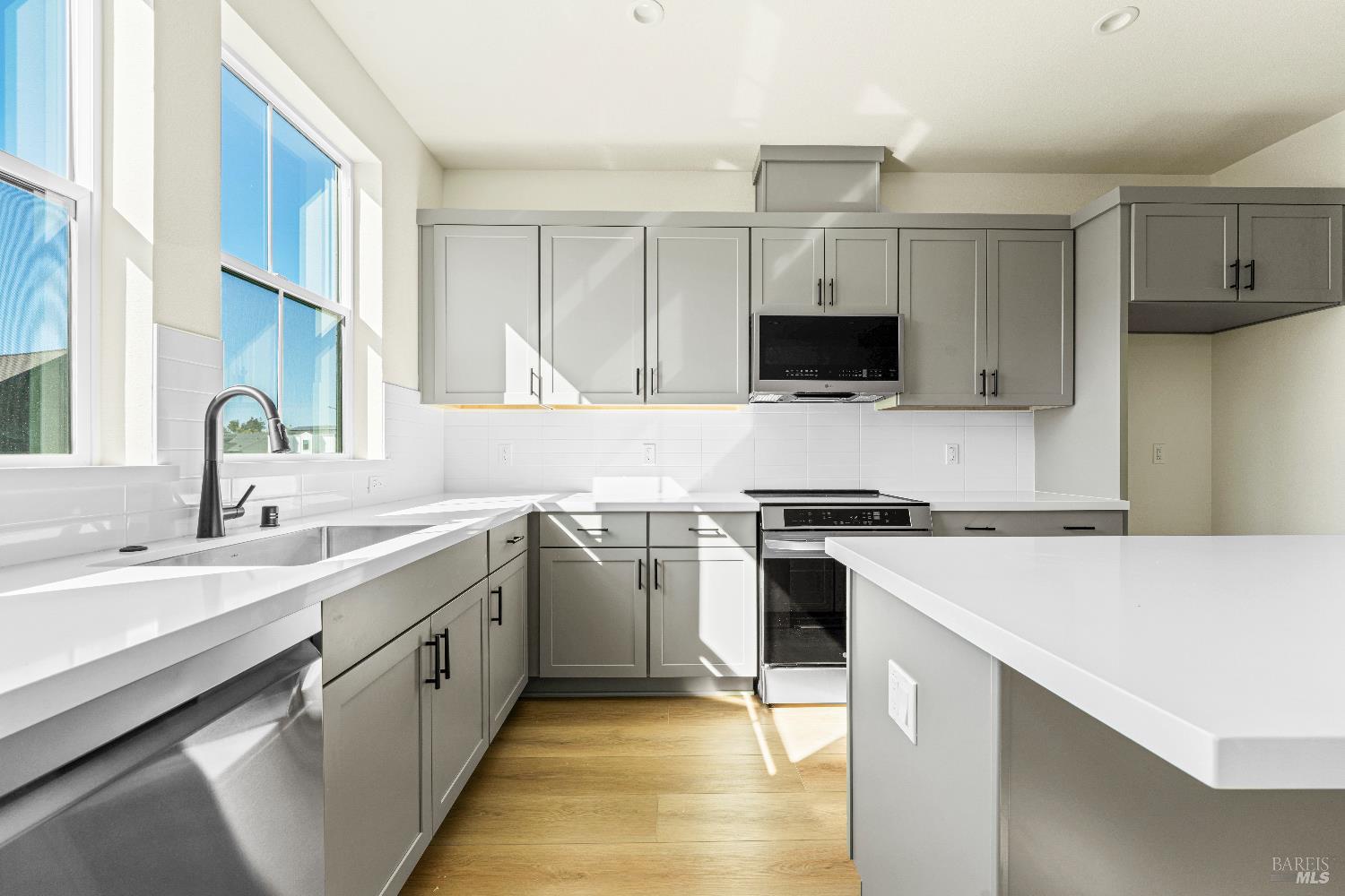 a kitchen with stainless steel appliances granite countertop a stove top oven a sink and a oven