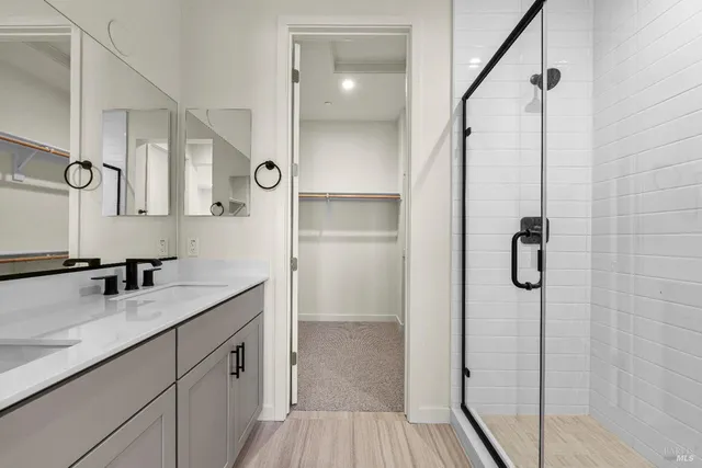 a bathroom with a shower sink and mirror