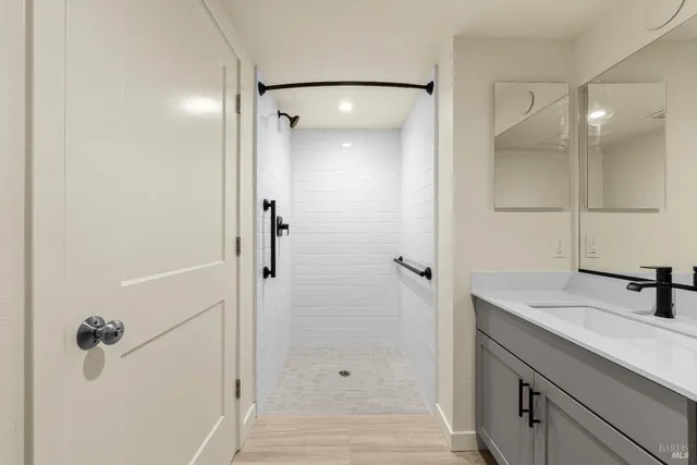 a bathroom with a sink a toilet and mirror