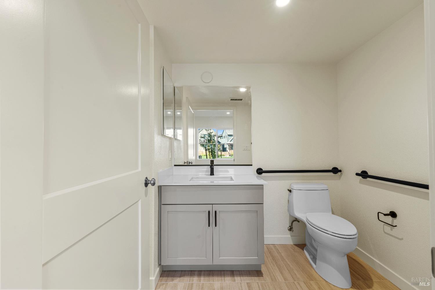 209 Wellness Way Rohnert Park, CA 94928 - Photo 28 of 30 a bathroom with a sink a toilet and mirror