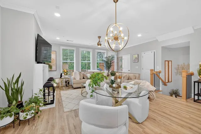 a living room with furniture a large window and a flat screen tv