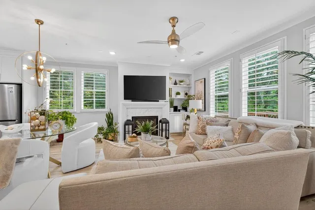 a living room with furniture a fireplace and a flat screen tv