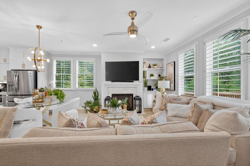 425 Retreat Lane Canton, GA 30114 - Photo 15 of 55 a living room with furniture a fireplace and a chandelier