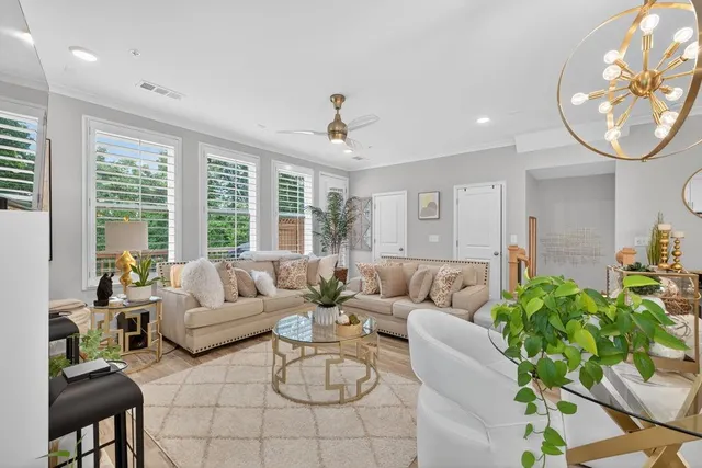 a dining room with furniture and a potted plant