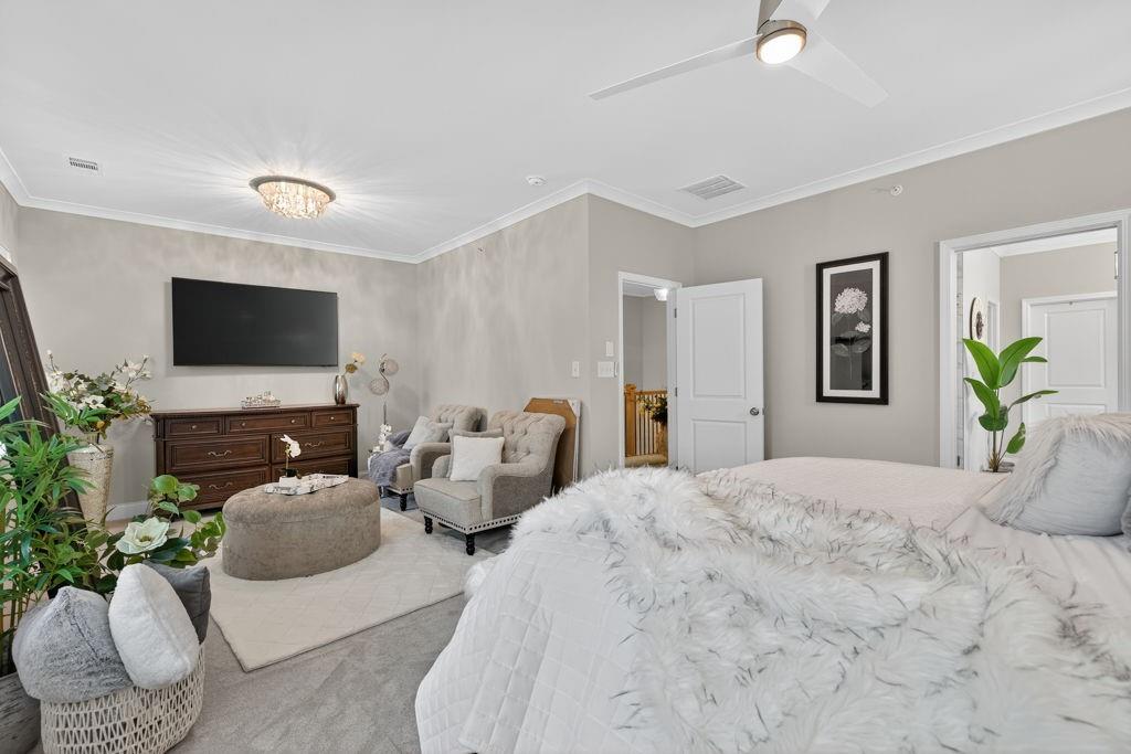 425 Retreat Lane Canton, GA 30114 - Photo 25 of 55 a bedroom with a bed a couch and a flat screen tv