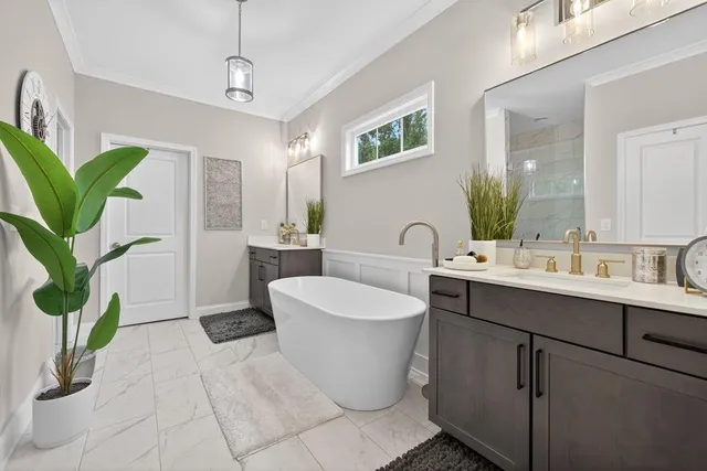 a white bath tub sitting next to a white sink