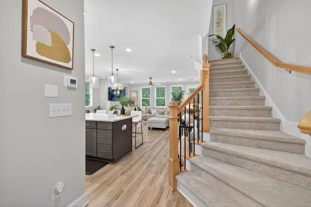 a kitchen with kitchen island granite countertop a sink a counter space appliances and cabinets