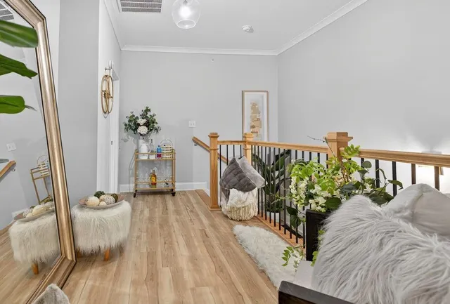 a white toilet sitting next to a white sink and a shower curtain