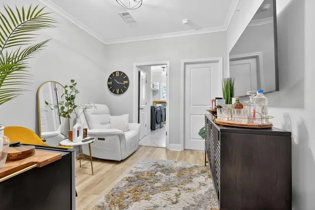 a very nice looking dining room with furniture and a chandelier