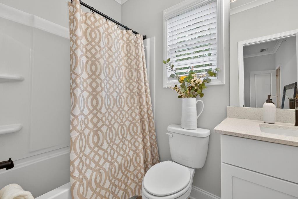 425 Retreat Lane Canton, GA 30114 - Photo 35 of 55 a white toilet sitting next to a white sink and a shower curtain