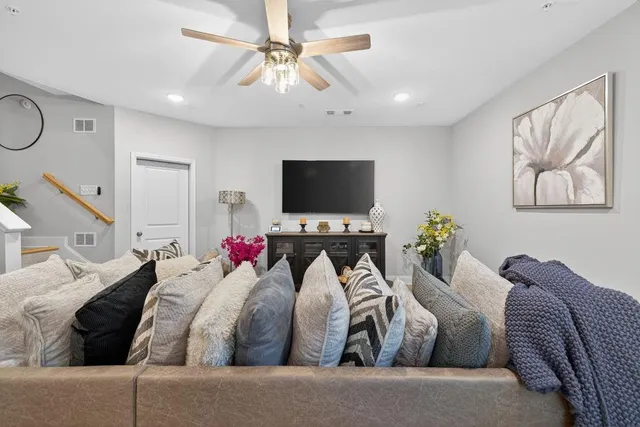 a living room with furniture and a chandelier