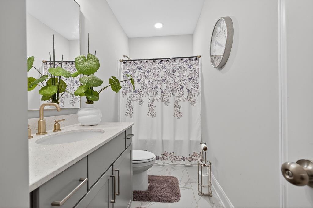 425 Retreat Lane Canton, GA 30114 - Photo 44 of 55 a bathroom with a granite countertop sink a toilet and shower