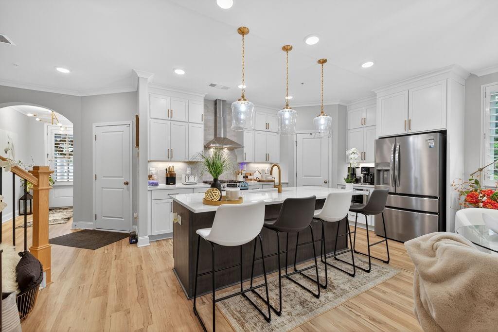 425 Retreat Lane Canton, GA 30114 - Photo 6 of 55 a kitchen with stainless steel appliances kitchen island granite countertop a dining table chairs and a refrigerator