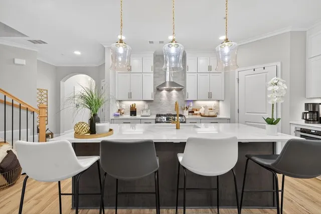 a kitchen with stainless steel appliances kitchen island a refrigerator and a view of living room