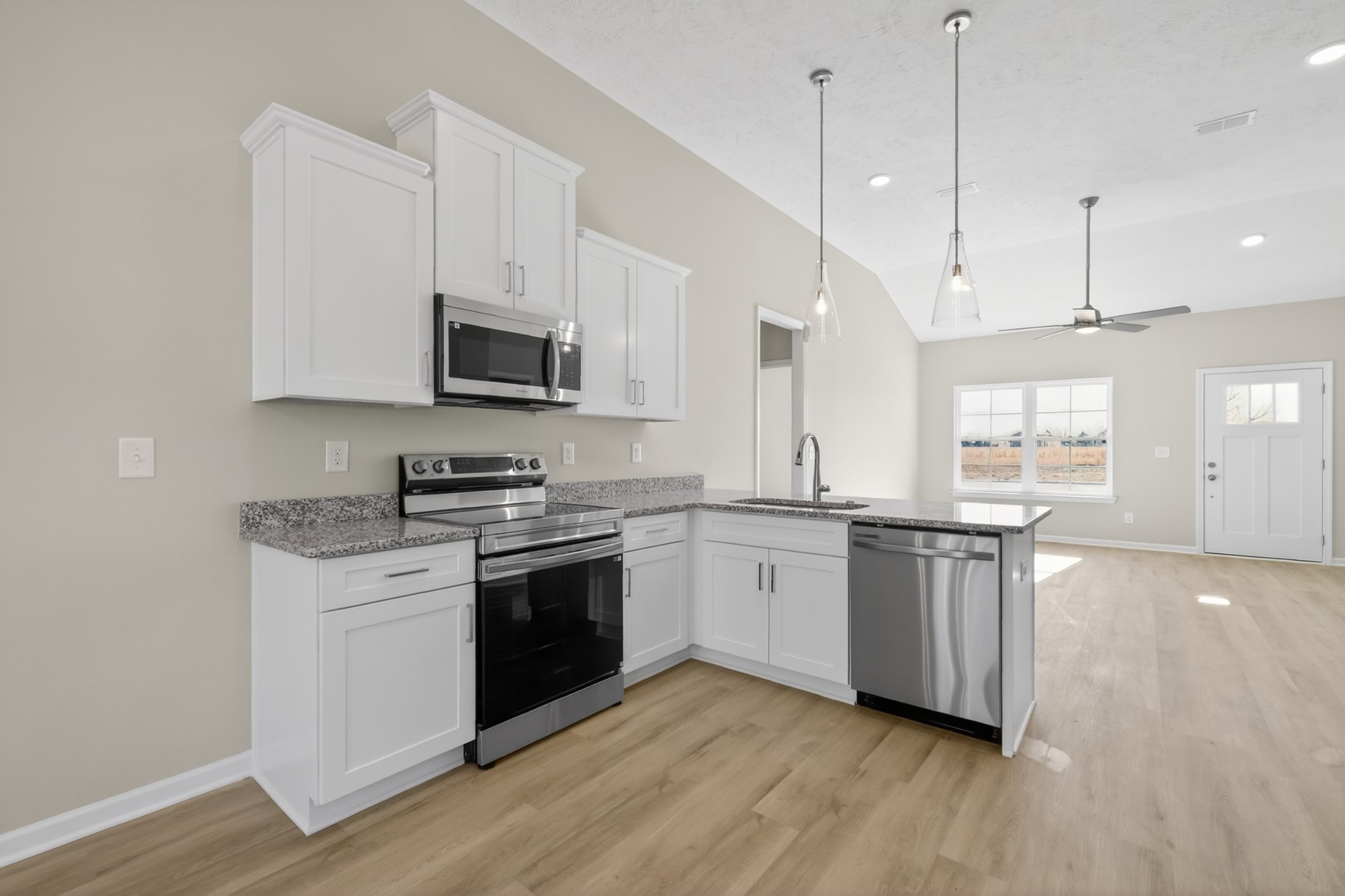 336 North Fork Branch Road Tullahoma, TN 37388 - Photo 11 of 34 a kitchen with stainless steel appliances granite countertop a stove a sink and a microwave