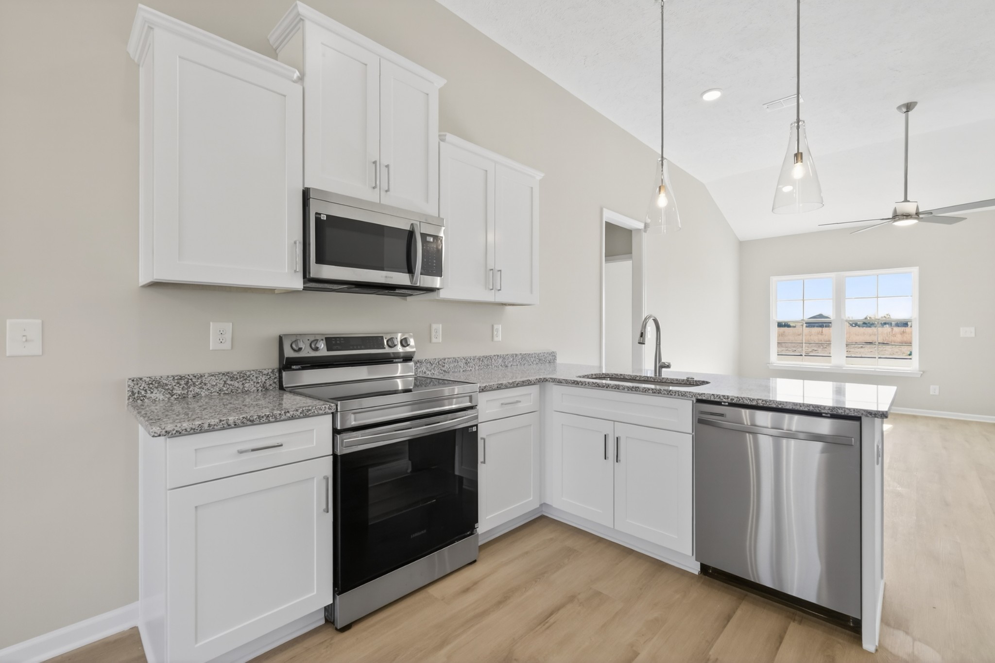 336 North Fork Branch Road Tullahoma, TN 37388 - Photo 12 of 34 a kitchen with granite countertop cabinets stainless steel appliances and wooden floor