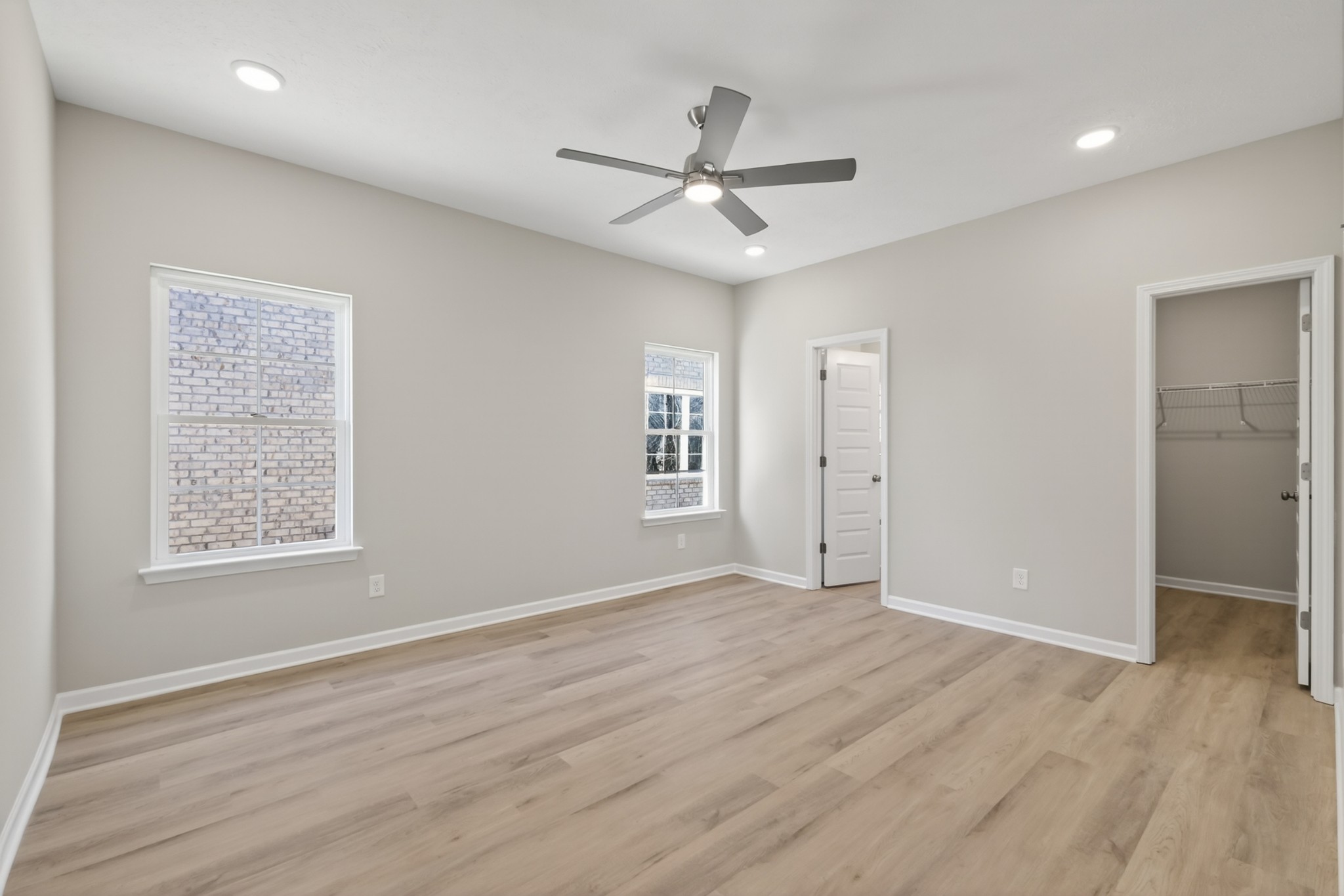 336 North Fork Branch Road Tullahoma, TN 37388 - Photo 17 of 34 an empty room with wooden floor ceiling fan and windows