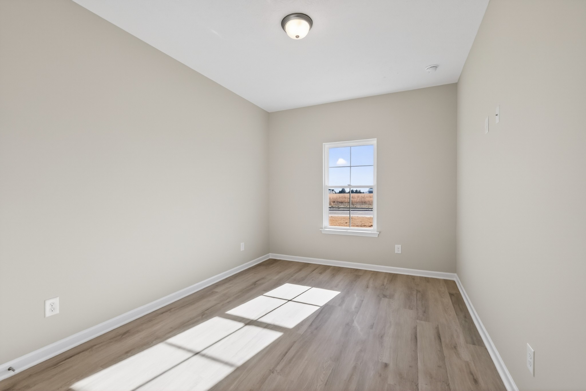 336 North Fork Branch Road Tullahoma, TN 37388 - Photo 23 of 34 an empty room with wooden floor and windows