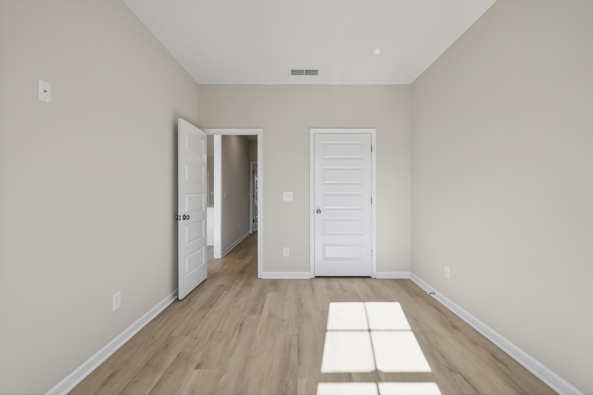 336 North Fork Branch Road Tullahoma, TN 37388 - Photo 24 of 34 an empty room with wooden floor and white doors