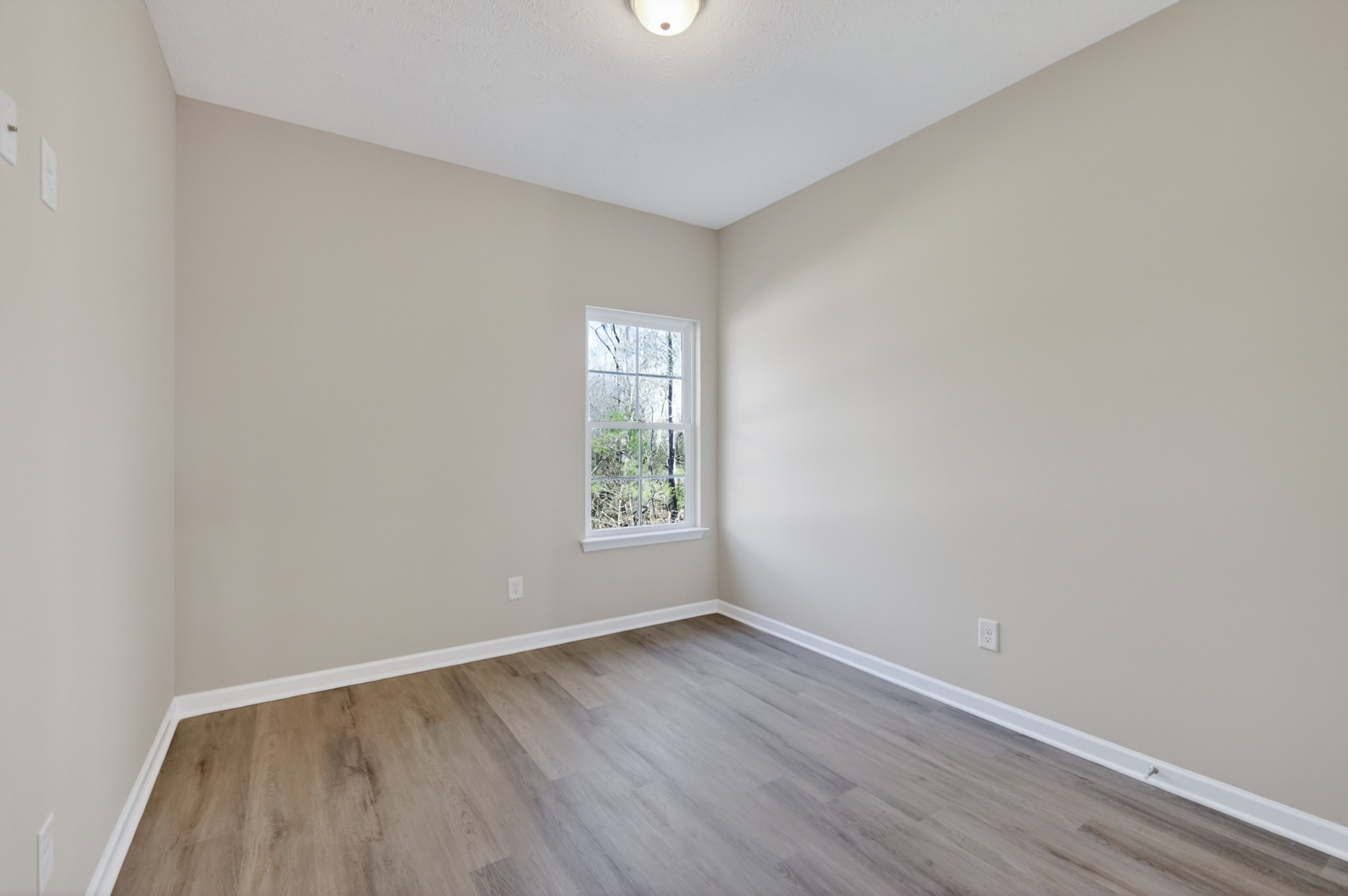 336 North Fork Branch Road Tullahoma, TN 37388 - Photo 28 of 34 an empty room with wooden floor and windows
