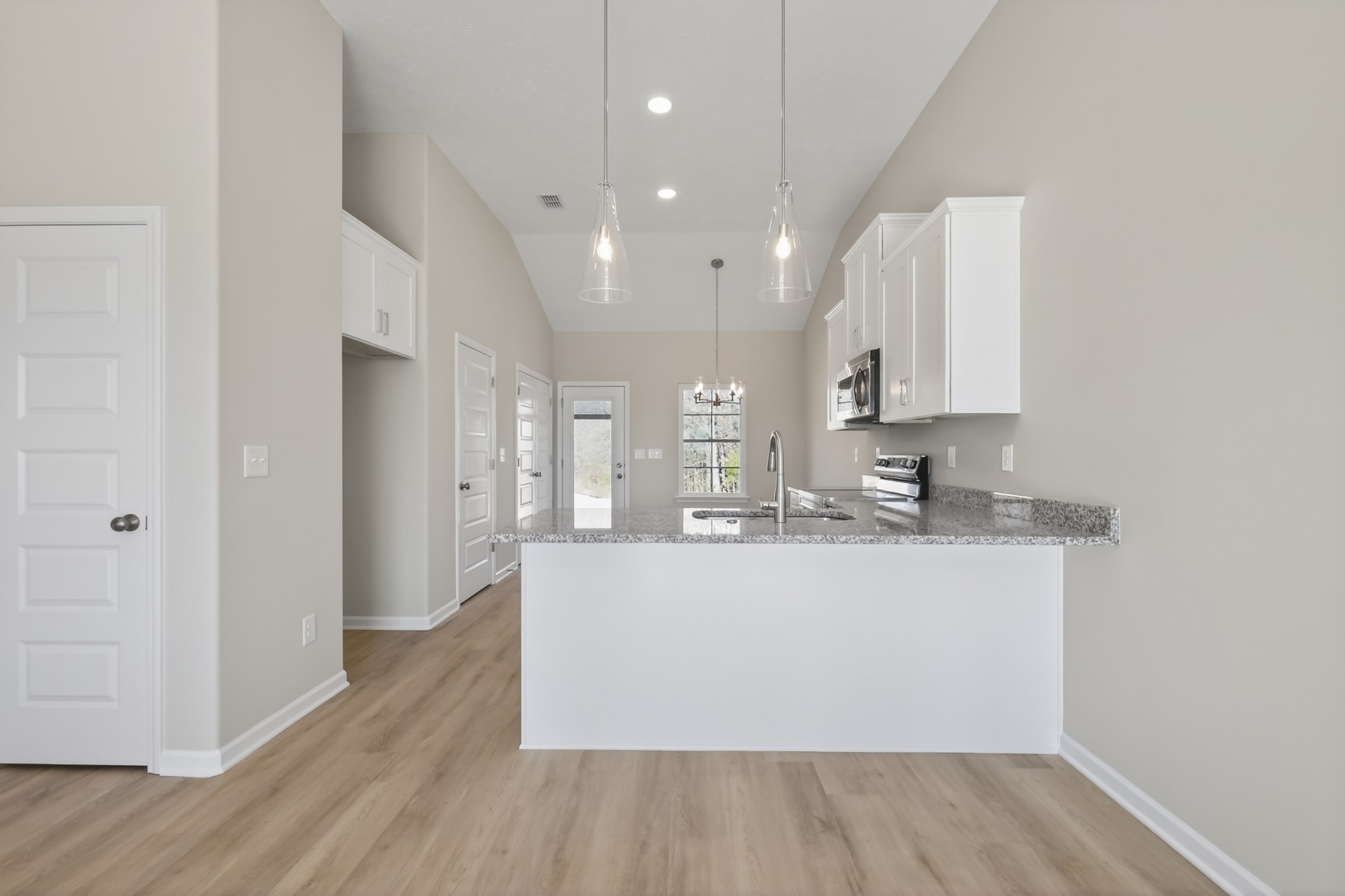 336 North Fork Branch Road Tullahoma, TN 37388 - Photo 9 of 34 a large white kitchen with wooden floor