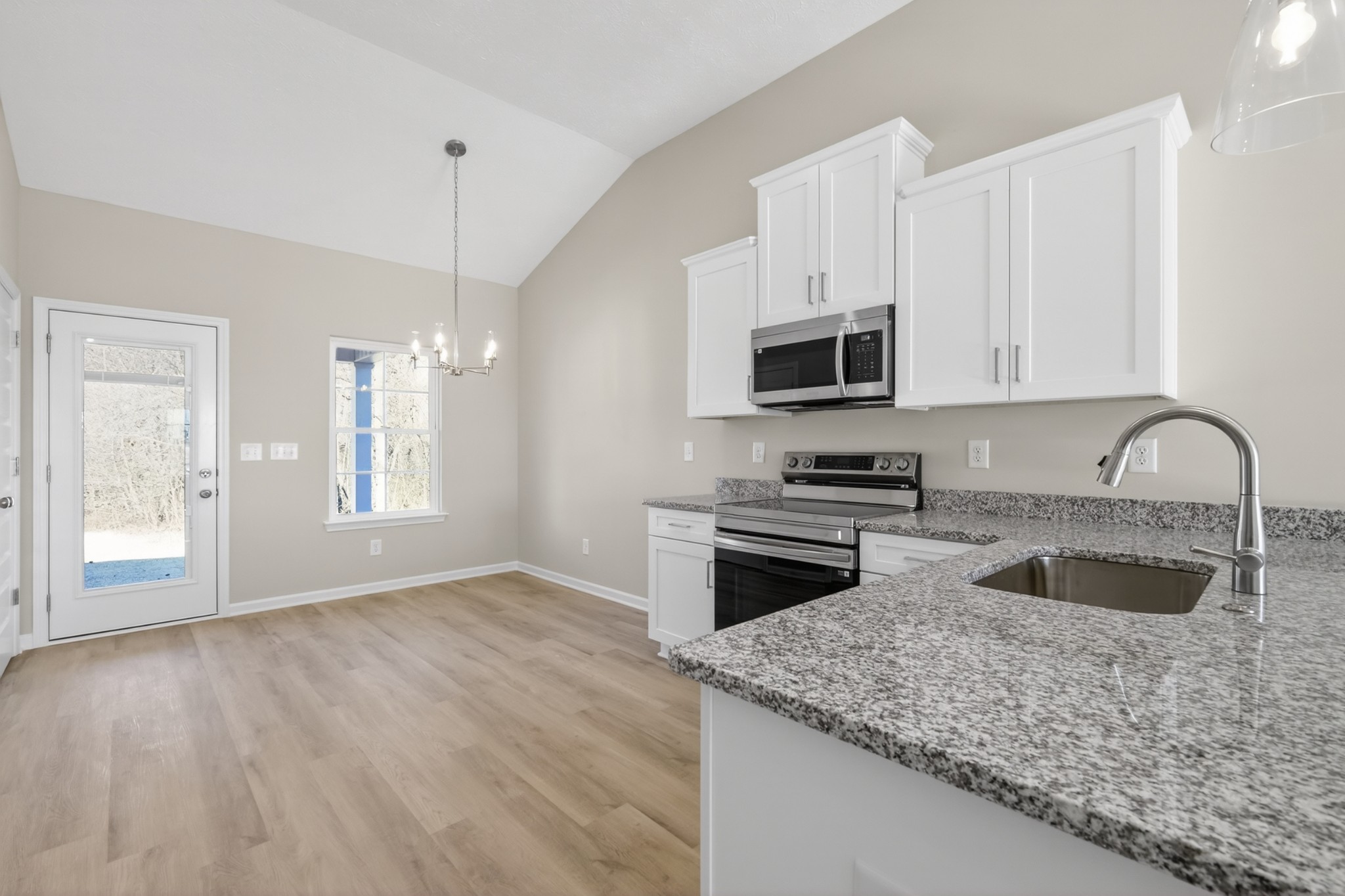 336 North Fork Branch Road Tullahoma, TN 37388 - Photo 10 of 34 a kitchen with granite countertop a stove a sink and a microwave