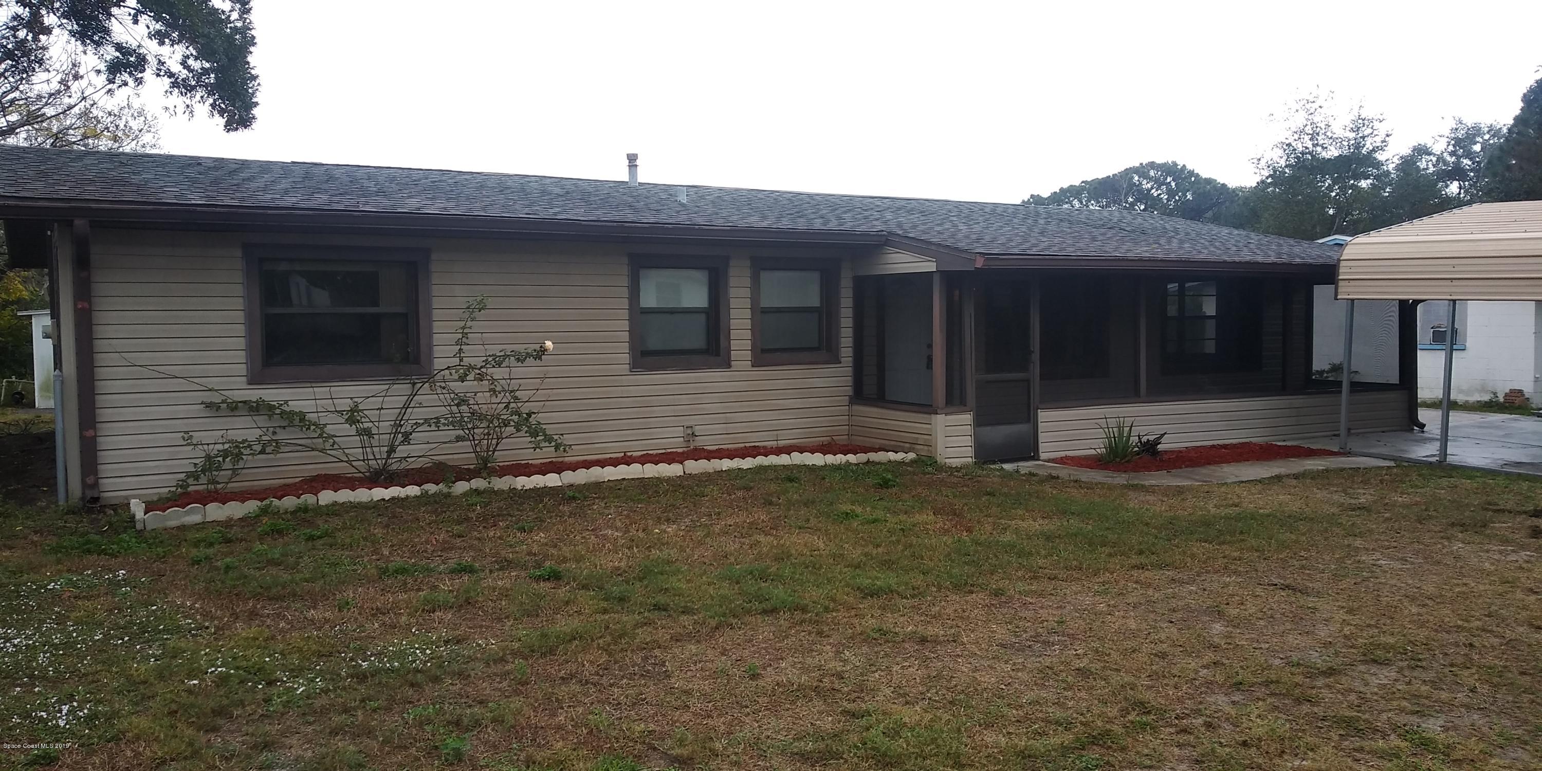 2465 Dolphin Road Titusville, FL 32780 - Photo 1 of 40 a front view of house with yard