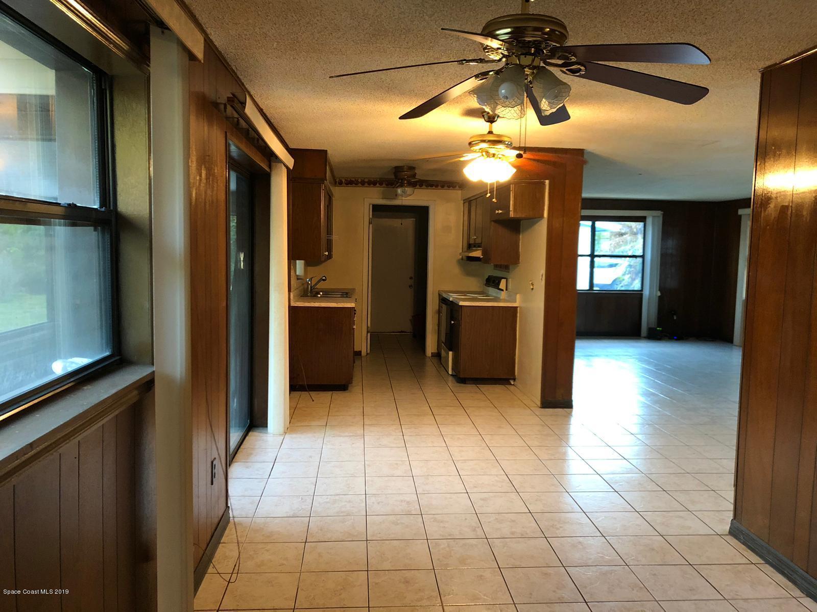 2465 Dolphin Road Titusville, FL 32780 - Photo 14 of 40 a view of a hallway with a chandelier