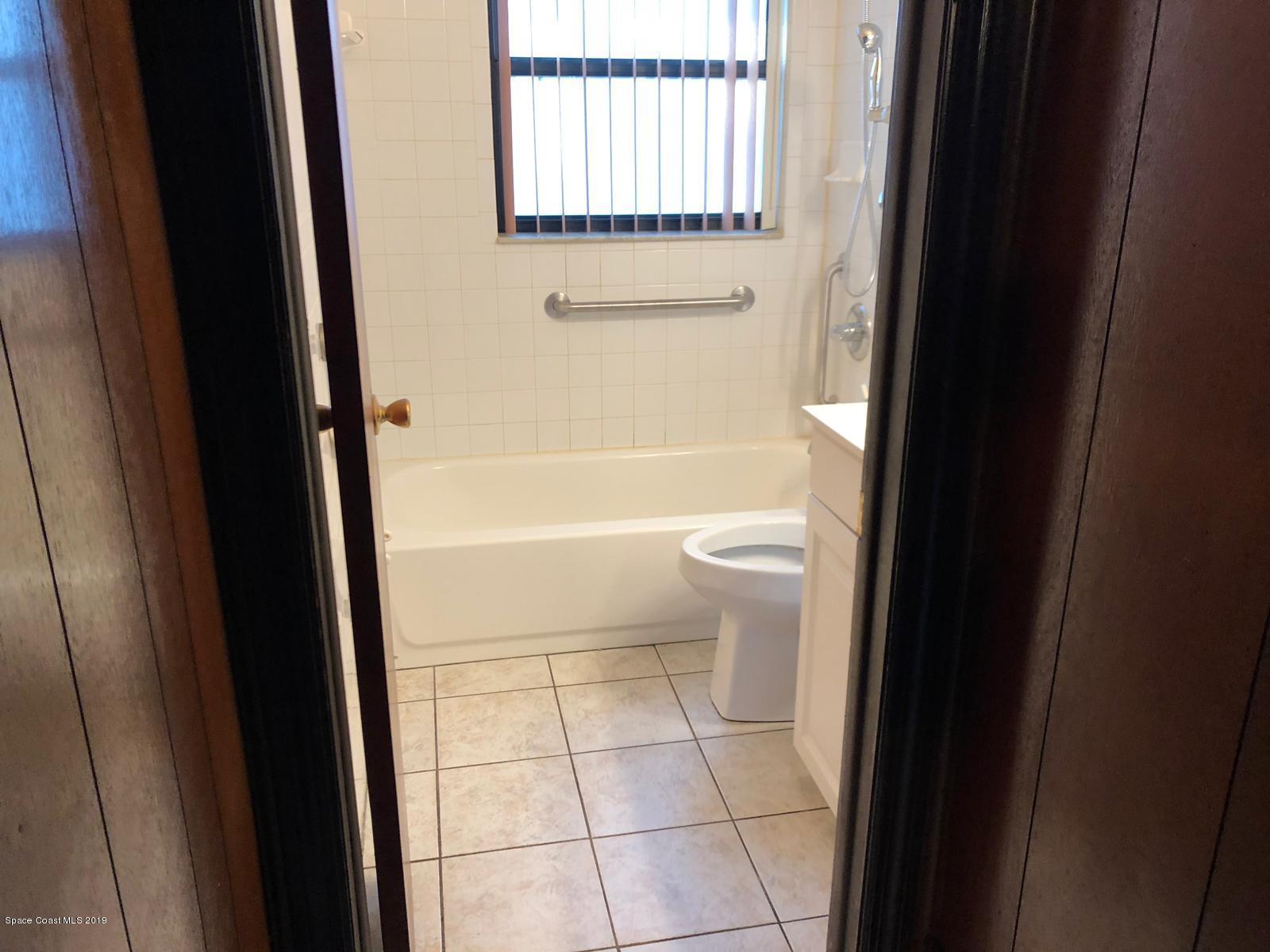 2465 Dolphin Road Titusville, FL 32780 - Photo 17 of 40 a bathroom with a toilet a sink and a shower