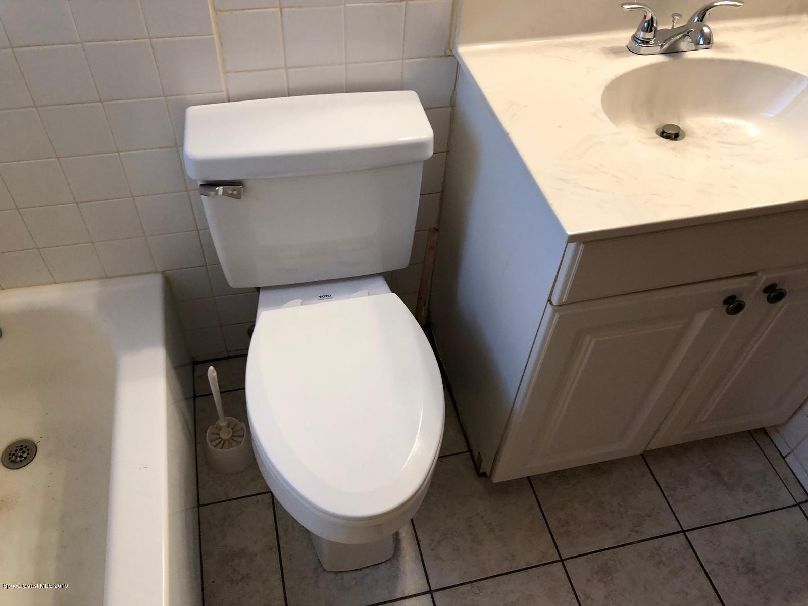 2465 Dolphin Road Titusville, FL 32780 - Photo 21 of 40 a bathroom with a sink and toilet