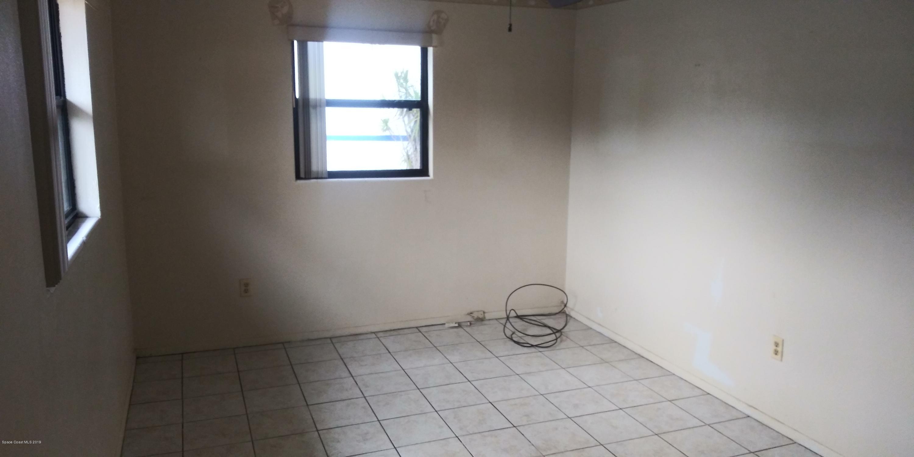 2465 Dolphin Road Titusville, FL 32780 - Photo 22 of 40 a view of an empty room and window
