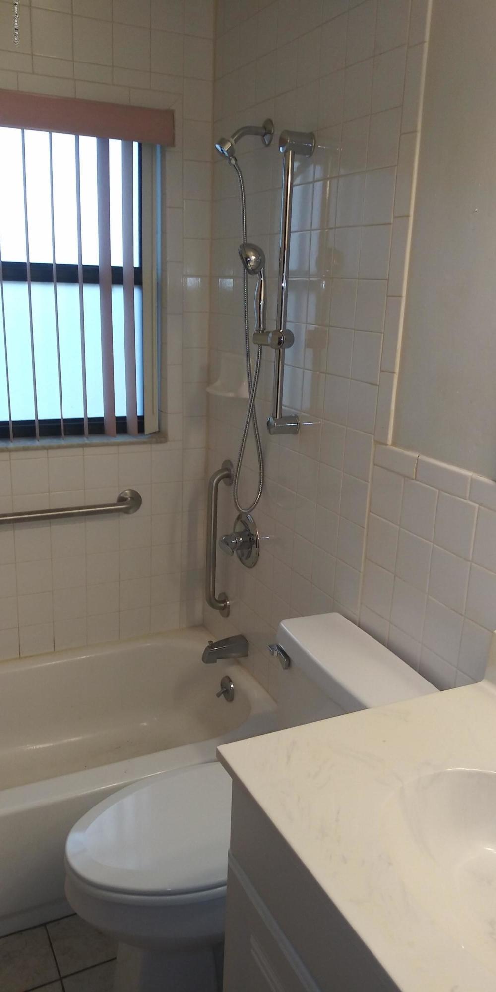 2465 Dolphin Road Titusville, FL 32780 - Photo 26 of 40 a bathroom with a sink a toilet and shower