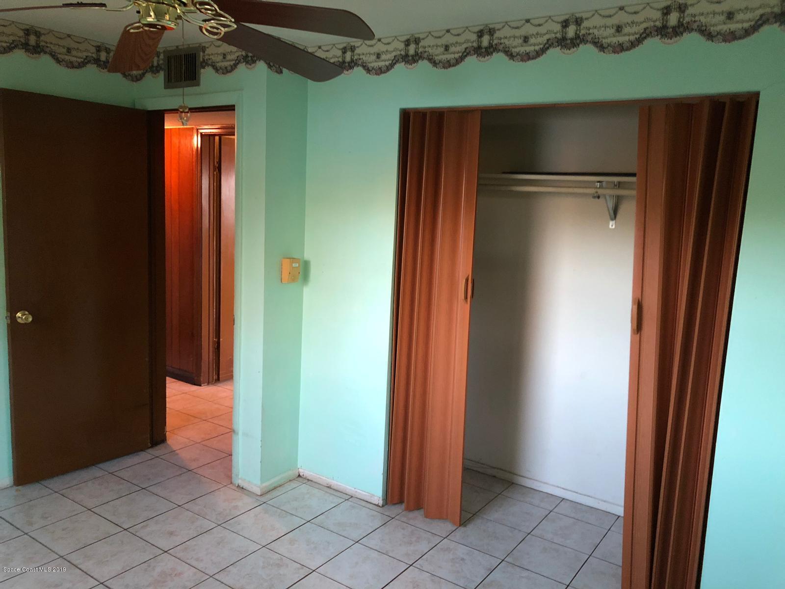 2465 Dolphin Road Titusville, FL 32780 - Photo 35 of 40 an empty room with wooden floor and closet
