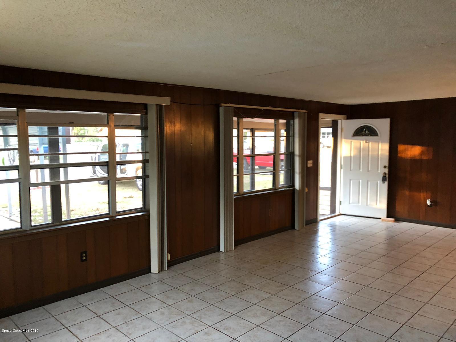 2465 Dolphin Road Titusville, FL 32780 - Photo 7 of 40 wooden floor in an empty room with a window
