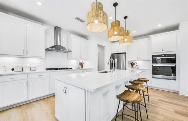 a kitchen with a table chairs and a stove