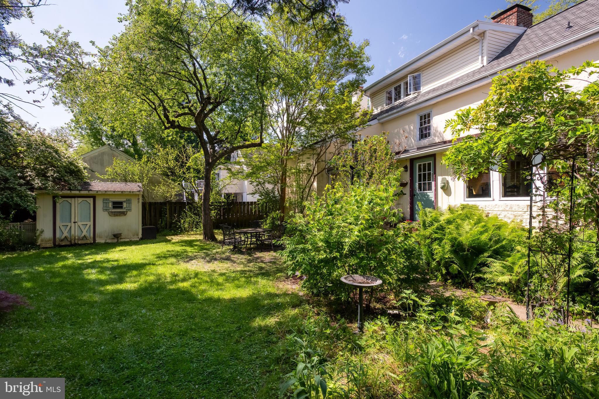 38 Old Lancaster Road Devon, PA 19333 - Photo 32 of 32 a backyard of a house with table and chairs and potted plants