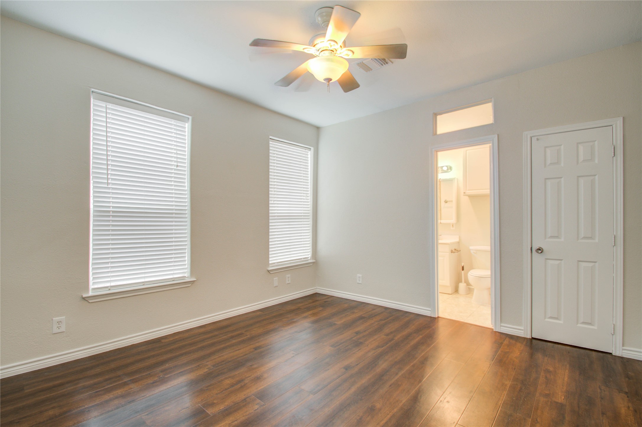 2119 Kane Street Houston, TX 77007 - Photo 12 of 29 a view of an empty room with wooden floor and a window
