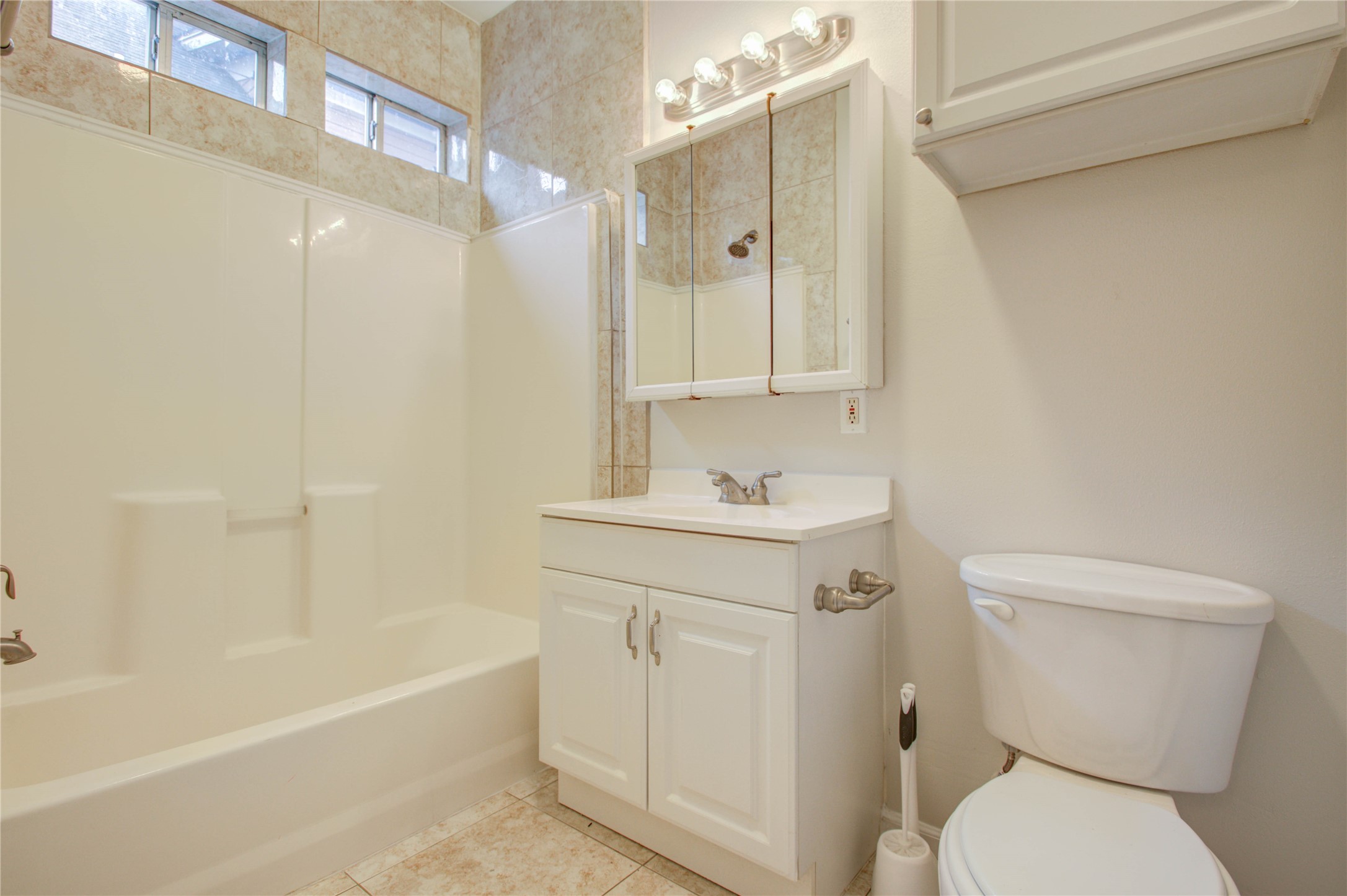 2119 Kane Street Houston, TX 77007 - Photo 14 of 29 a bathroom with a sink a toilet and shower