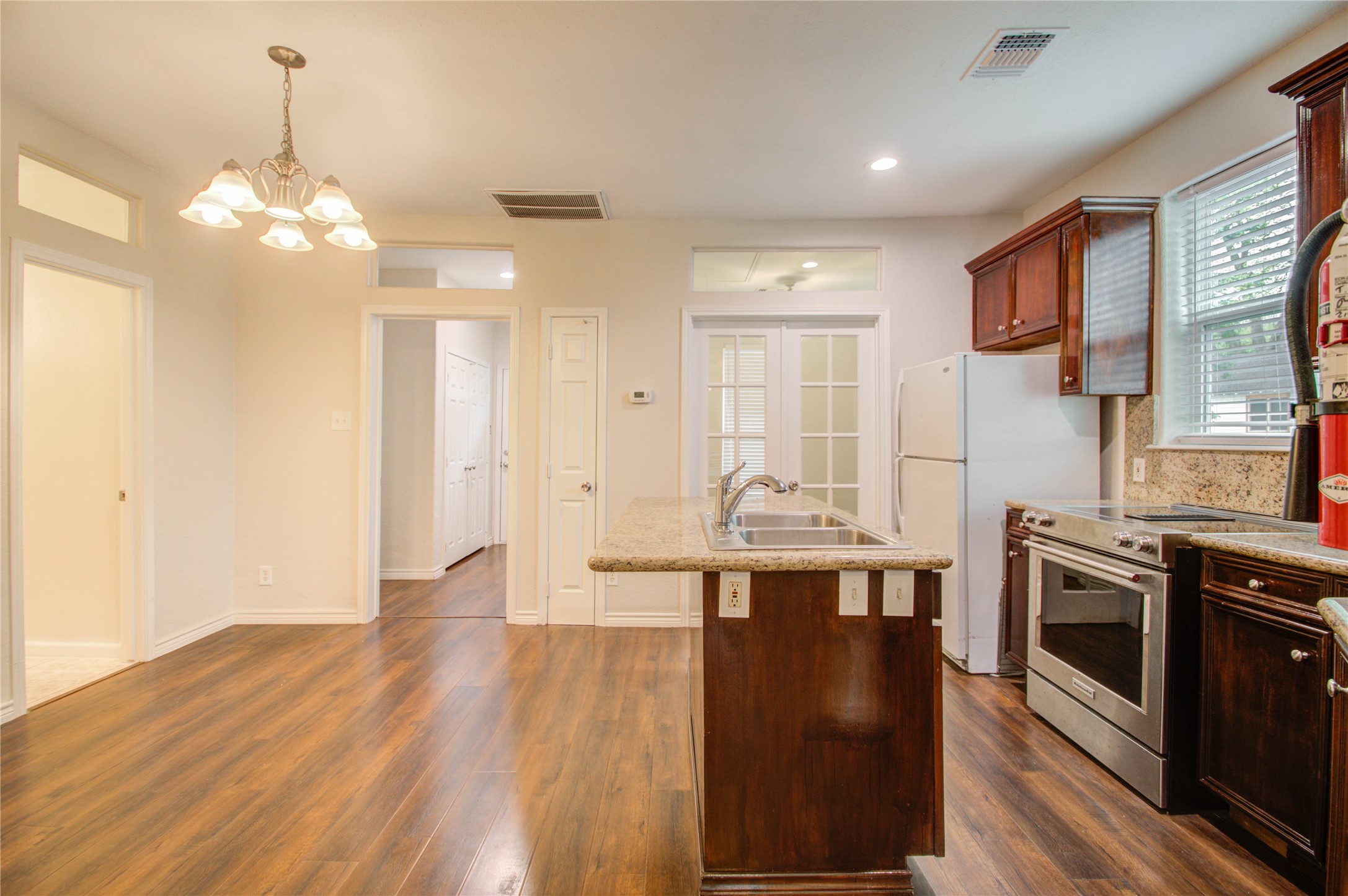 2119 Kane Street Houston, TX 77007 - Photo 17 of 29 a kitchen with stainless steel appliances granite countertop a stove and cabinets with wooden floor